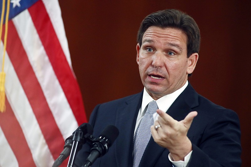Photo/Phil Sears/The Associated Press / Florida Gov. Ron DeSantis answers questions from the media in the Florida Cabinet following his State of the State address during a joint session of the Senate and House of Representatives on Tuesday, March 7, 2023, at the state Capitol in Tallahassee, Fla.