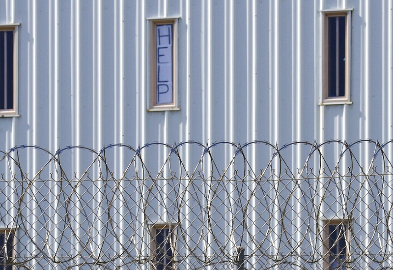 AP Photo by Kim Chandler / A sign reads "Help" in the window of an inmate cell seen in 2019 during a tour by state officials at Holman Correctional Facility in Atmore, Ala. The state Senate on Thursday approved a bill that would change the rules for "good time" incentives in Alabama prisons.