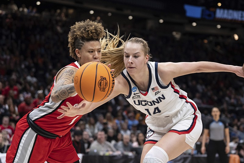 AP photo by Stephen Brashear / UConn forward Dorka Juhasz, right, and Ohio State guard Rikki Harris battle for a loose ball during the first half of an NCAA tournament Sweet 16 game on Saturday in Seattle.