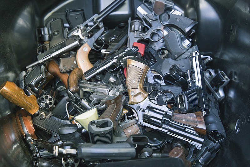 Michael Louis Slebodnik via The New York Times / In an undated handout photo, some of the 772 guns collected in exchange for gift cards at a Gun By Gun buyback event in another city are pictured.