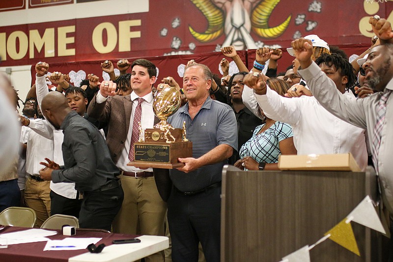 Staff photo by Olivia Ross / The team, coaches, and partners raise their rings for a group photo. Tyner celebrated being 2022 Class 2A State Football Champions with a Ring Ceremony on Monday, March 27, 2023.