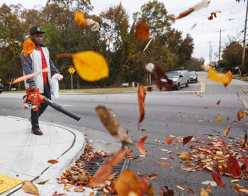 Staff Photo / Jemarow Tillison blows leaves off the sidewalk on Brainerd Road in 2018 in Chattanooga.