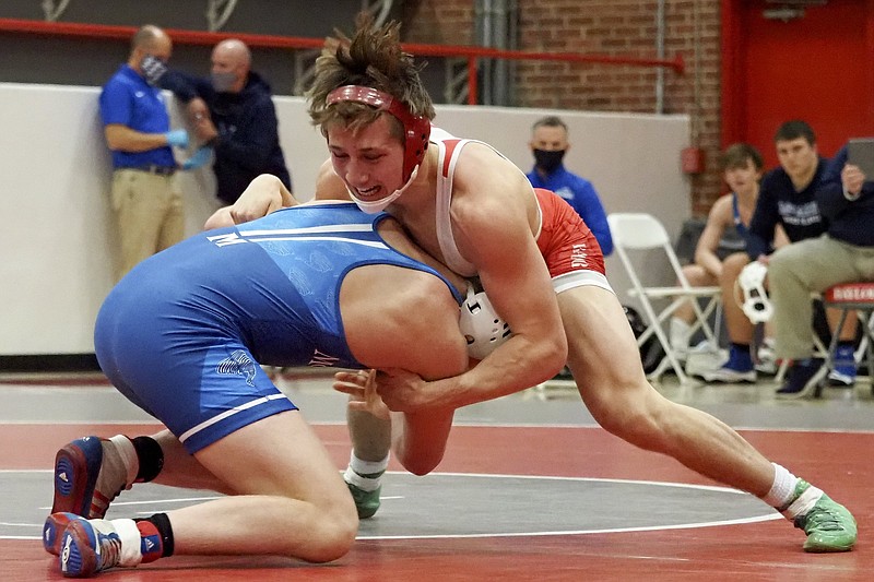 Staff photo / Baylor's Garrison Dendy, top, wrestles McCallie's Emory Taylor in a 152-pound bout in January 2021. Dendy, who won four individual state championships from 2019-22, is among the contributors to the Red Raiders' rich legacy as a wrestling program.