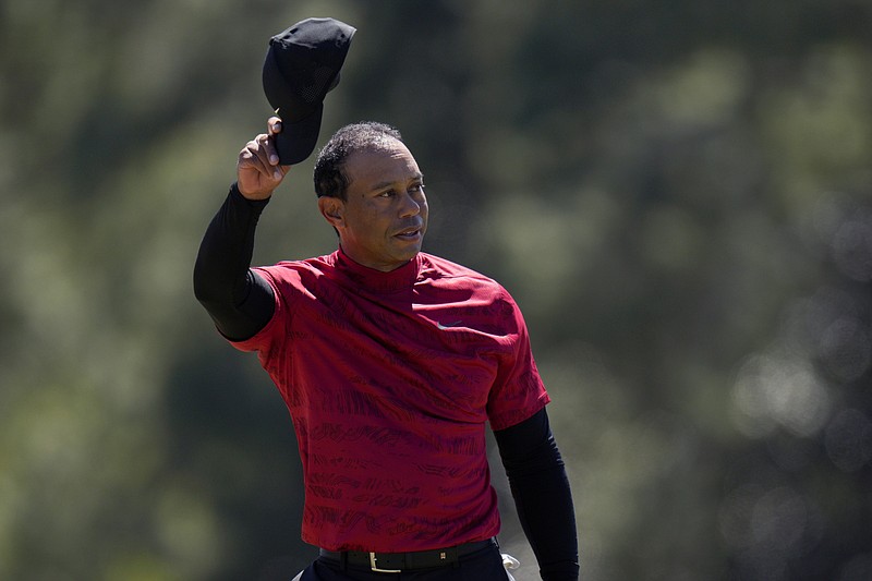 AP photo by Jae C. Hong / Tiger Woods tips his cap on the 18th green during the final round of the Masters last April in Augusta, Ga. Woods, who has five green jackets among his 15 major championships, will be back at the Masters when the first major of the year tees off Thursday in Georgia.