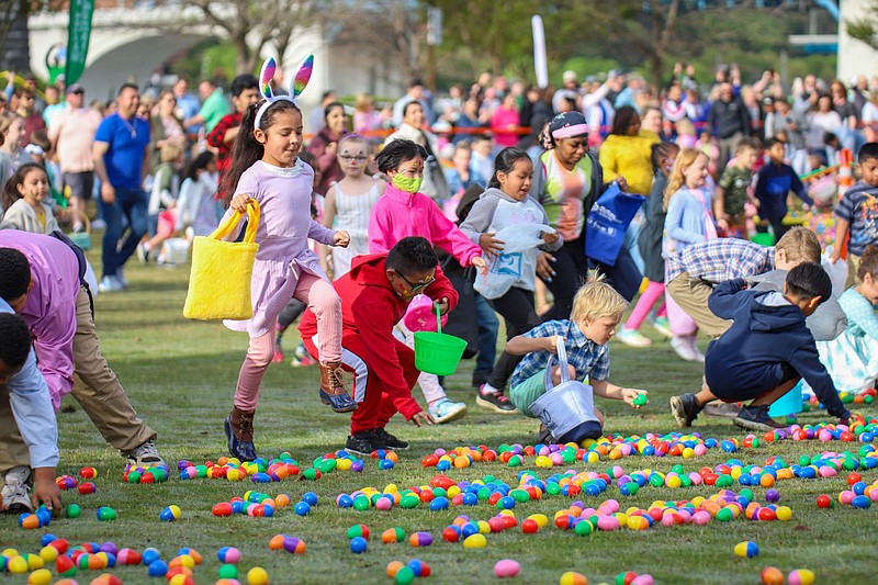 Staff file photo by Olivia Ross / Children pick up as many eggs as they can during Easter at Coolidge on April 17, 2022. The event, presented by Stuart Heights Baptist Church, featured an egg hunt, live music and Easter worship service.