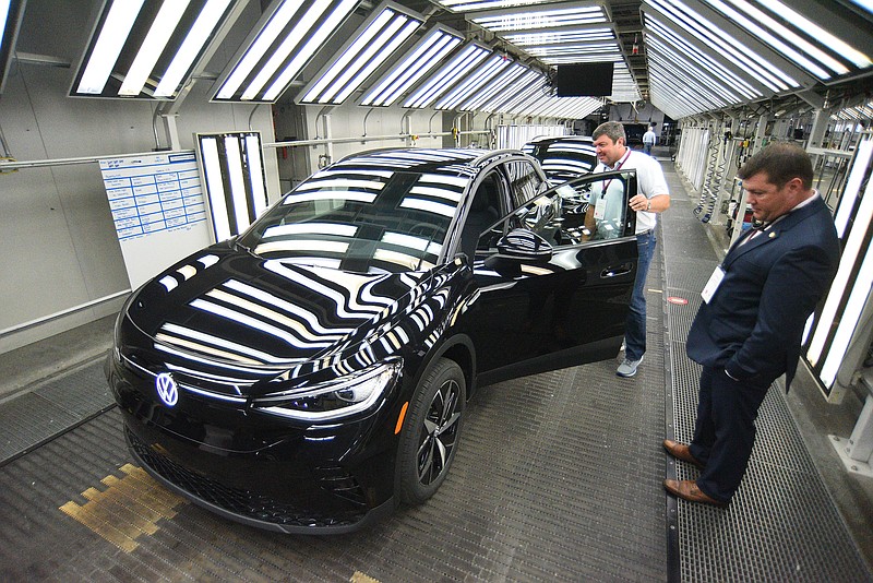 Staff Photo by Matt Hamilton / Visitors look over the all-electric Volkswagen ID.4 SUV at the Chattanooga Volkswagen Assembly Plant on Oct. 14. Sales of the ID.4 more than tripled their year-ago volumes during the first three months of 2023.