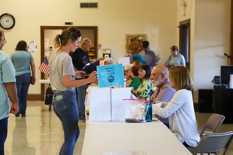 Staff Photo by Olivia Ross  / Voters are given their ballots at Red Bank Calvary Baptist Church on Nov. 8.