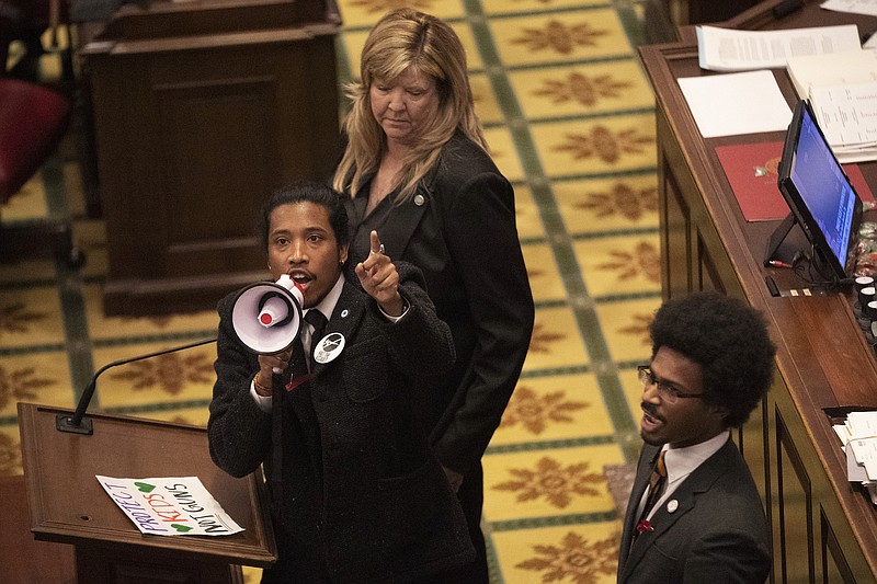 Tennessee State Representative Justin Jones calls on his colleagues to pass gun control legislation from the well of the House Chambers during the legislative session at the State Capitol Thursday, March 30, 2023 in Nashville, Tenn. (George Walker IV /The Tennessean via AP)