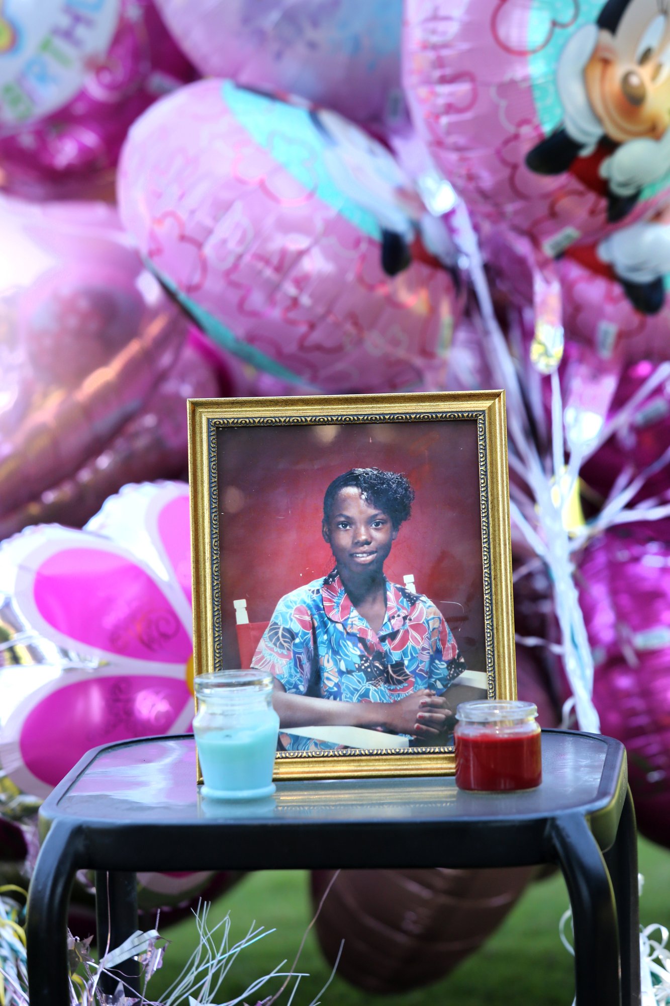 Staff photo by Erin O. Smith / A photo of Tonetta Carlisle sits on a table in front of birthday balloons prior to a balloon release on Aug. 31, 2019, in Coolidge Park.