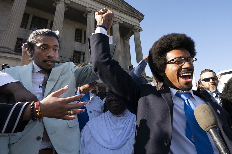 State Rep. Justin Jones, D-Nashville, and expelled Rep. Justin Pearson, D-Memphis, raise their hands just before Jones takes the oath of office outside the state Capitol Monday, April 10, 2023, in Nashville, Tenn. (AP Photo/George Walker IV)