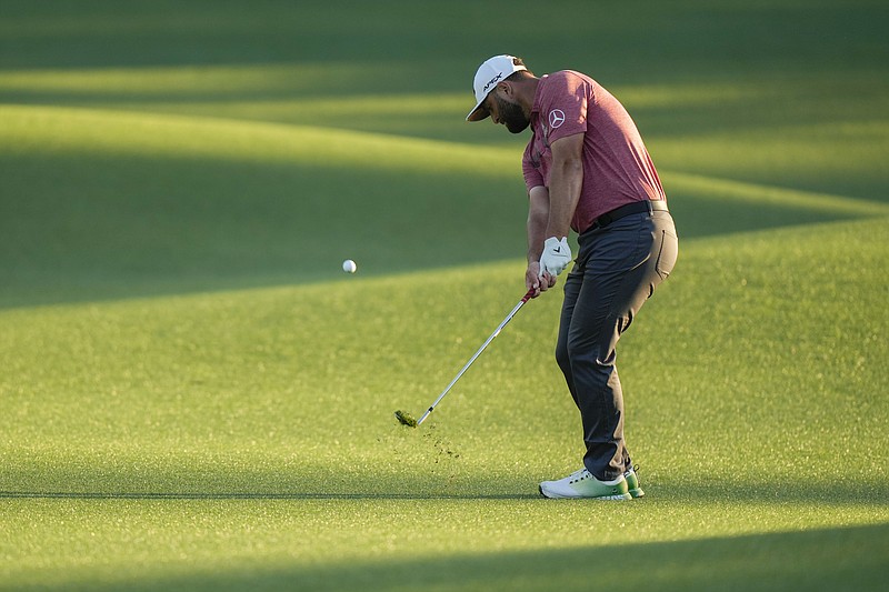 AP photo by Charlie Riedel / Jon Rahm chips to the 18th green at Augusta National on the way to winning the Masters on Sunday.