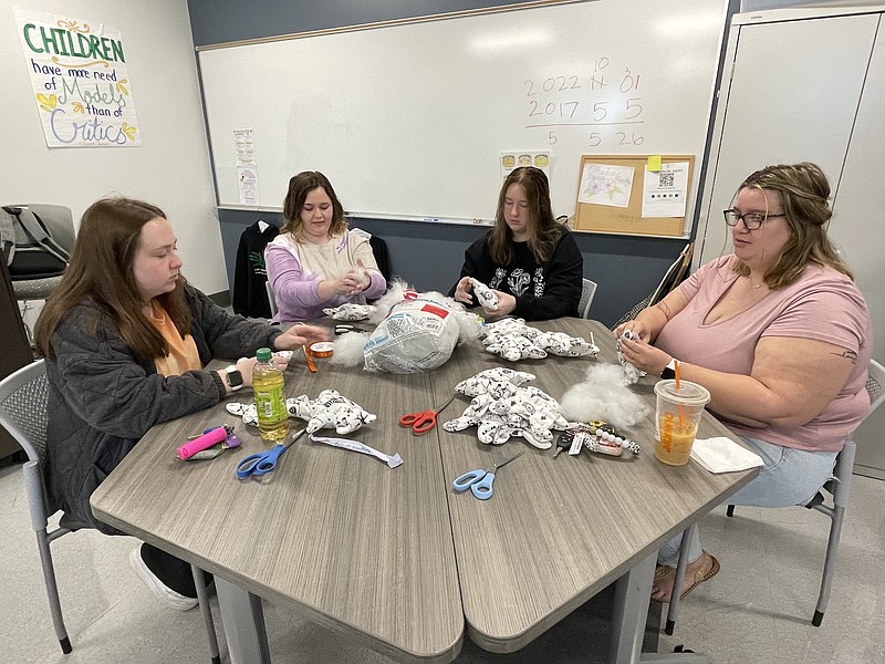 Contributed photo / Working on the teddy bear project, from left, are Family Dynamics students Samantha Chapman, Lindsey Kennedy, Kaydence Gryder and Paige Angel. They are stuffing and putting the finishing touches on the stuffed animals that were sent to students at The Convenant School in Nashville.