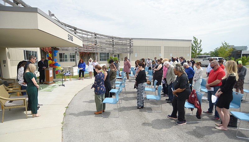 Staff photo by Matt Hamilton /  Those in attendance stand for the invocation during an event recognizing National Crime Victims Rights Week at the Family Justice Center on Friday.