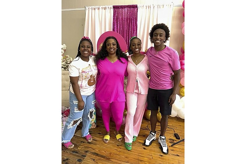 This undated photo provided by the family of Phil Dowdell shows from left, Zaniriah Dowdell, Latonya Allen, Alexis Dowdell and Phil Dowdell. Phil Dowdell was one of four young people killed when a shooting broke out at a Sweet 16 birthday party in Dadeville, Ala., on April 15. Dowdell was headed to Jacksonville State University in the fall. He planned to play football for the Gamecocks. (Family of Phil Dowdell via AP)