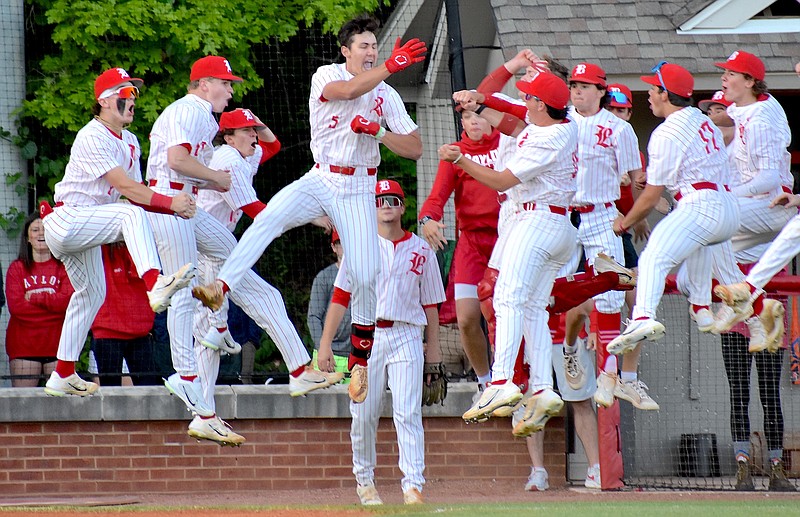 Staff photo by Patrick MacCoon / Baylor players jump up in unison as they celebrate the first of Henry Ford's (5) two home runs in Monday's 11-0 home victory over McCallie.