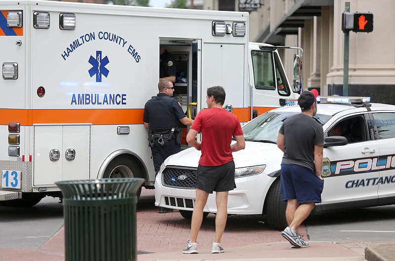 Staff photo / Hamilton County EMS and Chattanooga police officers help a pedestrian who was struck at the intersection of Georgia Avenue and M.L. King Boulevard on May 24, 2019, in Chattanooga.