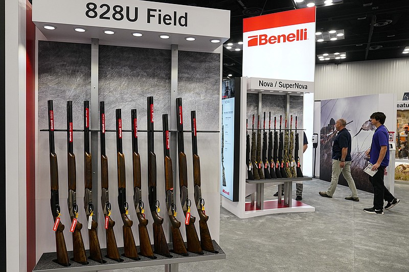 AP photo by Michael Conroy / Guests browse firearms in the Benelli display area of exhibits at the NRA's annual meeting on April 16 in Indianapolis.