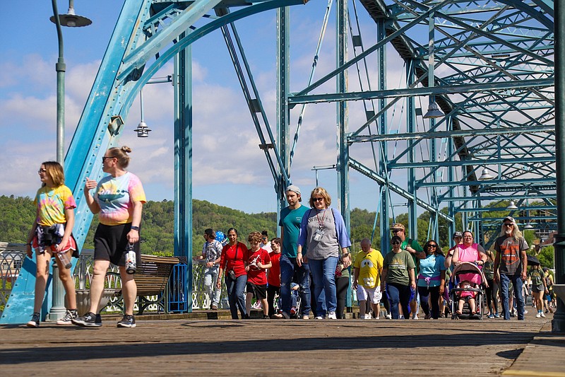 Staff Photo by Olivia Ross / Families walk along the Walnut Street Bridge on April 15 for the Chattanooga Autism Celebration Walk. Chattanooga Mayor Tim Kelly's proposed budget includes $18 million for renovations to the Walnut Street Bridge.