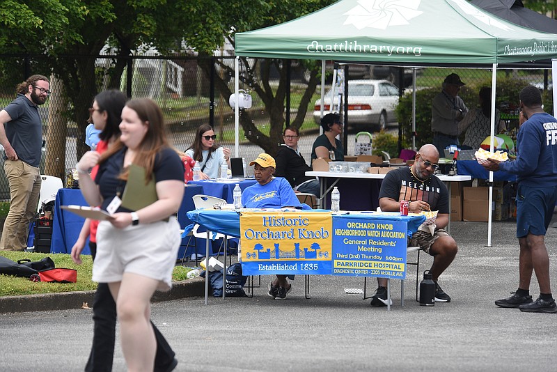 Staff photo by Matt Hamilton /  Visitors look over booths during the Orchard Knob Connected Communities Pilot Program celebration in a parking lot near Parkridge Hospital on Saturday.