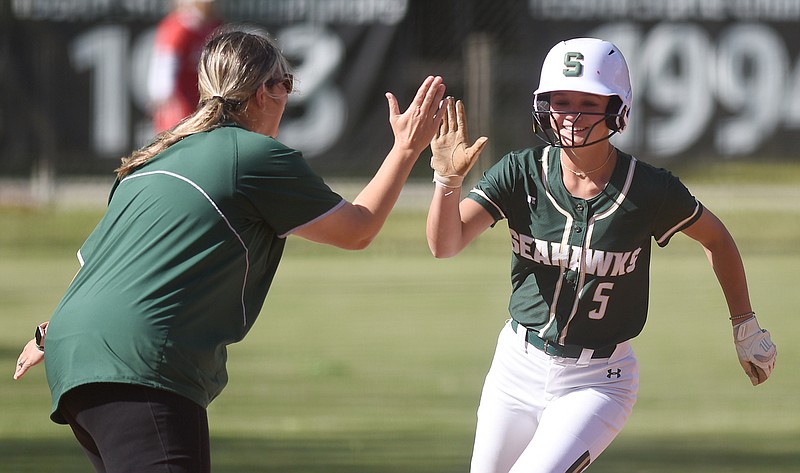 Staff photo by Matt Hamilton / Silverdale Baptist's (5) Kennedy Stinson exchanges a high five with coach Jackie Freeland as she rounds third for home after hitting a two-run homer at Baylor School on Tuesday, May 2, 2023.