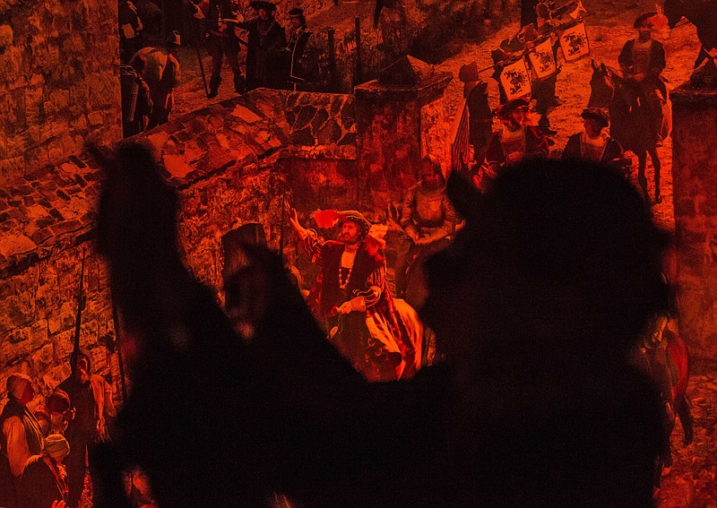 Visitors shoot photos in front of the monumental panoramic artwork 'Luther 1517' by artist Yadegar Asisi in Wittenberg, Germany, on Oct. 22, 2016. The panoramic picture, a highlight of the Luther Year 2017 in Wittenberg, is dedicated to the events that took place in Wittenberg 500 years ago, when the monk and scholar Martin Luther published his 95 Theses on the reform of the Catholic Church. /File/AP Photo/Jens Meyer