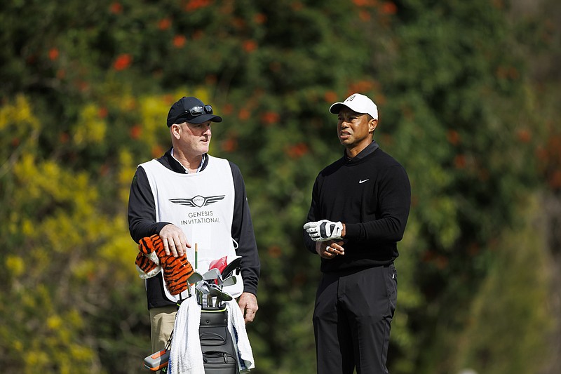 AP photo by Ryan Kang / Tiger Woods talks with caddie Joe LaCava during the second round of the Genesis Invitational on Feb. 17 at Riviera Country Club in Los Angeles.