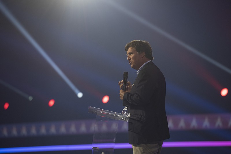 Photo/Rebecca Noble/The New York Times / Tucker Carlson, host of Tucker Carlson Tonight on Fox News, speaks during AmericaFest at Phoenix Convention Center in Phoenix, on Dec. 17, 2022. A text message sent by Tucker Carlson that set off a panic at the highest levels of Fox on the eve of its billion-dollar defamation trial showed its most popular host sharing his private, inflammatory views about violence and race; the discovery of the message contributed to a chain of events that ultimately led to Carlsons firing.