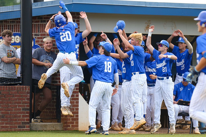 Staff photo by Olivia Ross / Ringgold cheers as Garrett Edgar (20) jumps in the air after making it home. Ringgold High School took on Columbus at home in the GHSA state quarterfinal game.