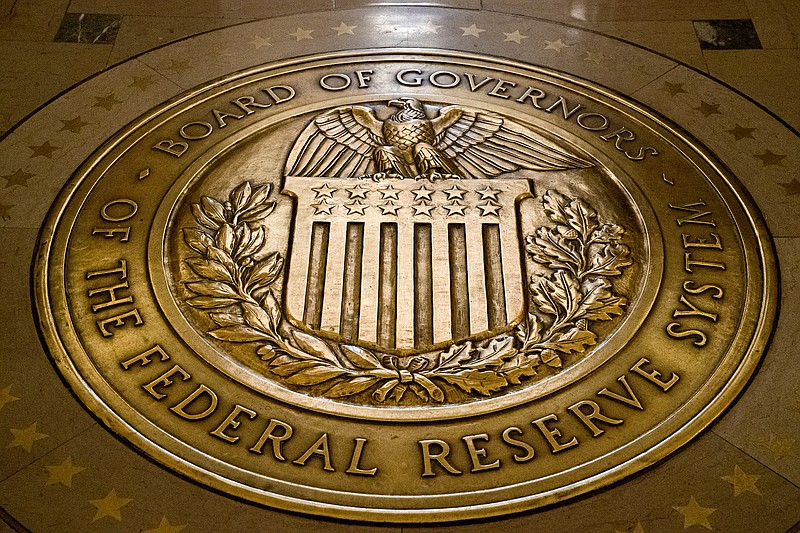 FILE - The seal of the Board of Governors of the United States Federal Reserve System is displayed in the ground at the Marriner S. Eccles Federal Reserve Board Building in Washington, Feb. 5, 2018. A Federal Reserve report Monday, May 8, 2023, showed that banks raised their lending standards for business and consumer loans in the aftermath of three large bank failures, a trend that could slow the economy in coming months. (AP Photo/Andrew Harnik, File)