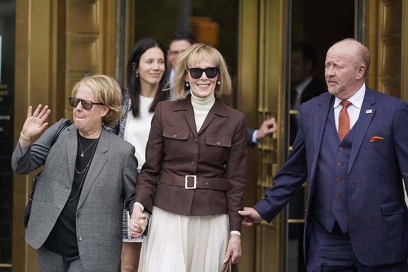 Photo/Seth Wenig/The Associated Press / E. Jean Carroll, center, walks out of Manhattan federal court onTuesday, May 9, 2023, in New York, after a jury found Donald Trump liable for sexually abusing the advice columnist in 1996 and awarded her $5 million.