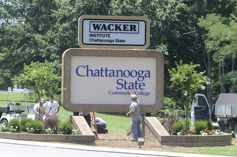 Staff file photo / A worker adjusts the letters on a sign Chattanooga State Community College.