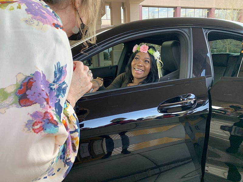 A pregnant military veteran receives a tiara at a drive-through baby shower run by the Atlanta VA Clinic. "We are very well aware of the maternal mortality statistics, which are terrible in the Southeast and impact Georgia in very high numbers," said Kathleen O'Loughlin, manager of the Atlanta VAs women veterans program. (Jess Mador/WABE)