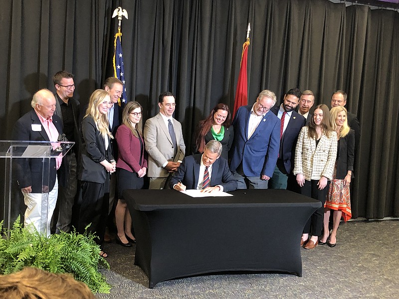 Staff photo by Andy Sher / Surrounded by business leaders and cabinet officials, Tennessee Gov. Bill Lee signs into law the Tennessee Works Tax Act during a ceremony at Lipscomb University on Thursday in Nashville.