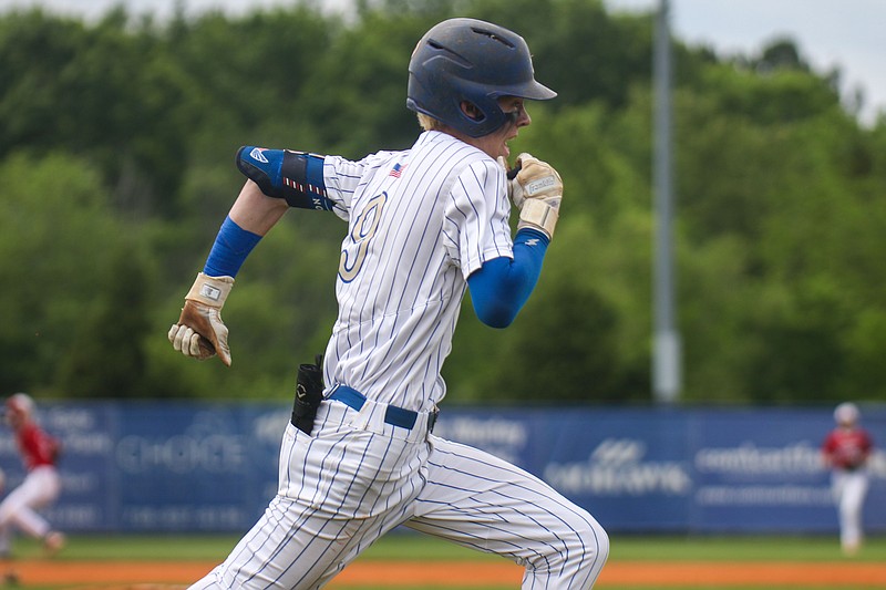 Staff photo by Olivia Ross / Ringgold's Sam Crew runs to first base during a GHSA Class AAA playoff game against visiting Savannah Christian on Saturday.