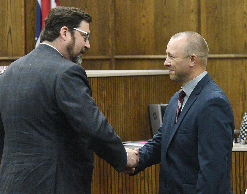 Staff Photo By Matt Hamilton / Attorney Ben McGowan shakes the hand of his client, Daniel Wilkey, after charges were dismissed against the latter at the Hamilton County Courts Building on Friday, May 12, 2023.