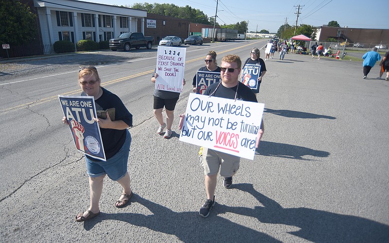 Staff photo by Matt Hamilton / Bus drivers hold signs while walking during the protest by Amalgamated Transit Union Local 1212 in front of First Student in Dalton, Ga., on Monday.