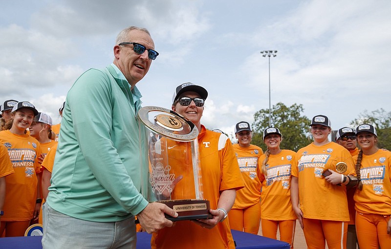 Tennessee Athletics photo / Southeastern Conference commissioner Greg Sankey presents Tennessee softball coach Karen Weekly with the league tournament championship trophy after last Saturday's 3-1 win over South Carolina in Fayetteville, Ark.