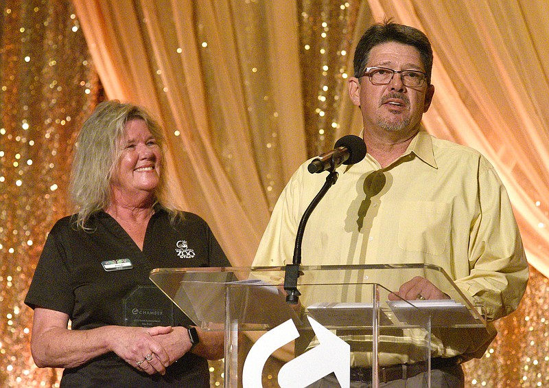 Staff Photo by Matt Hamilton / Chattanooga Zoo CEO Darde Long, left, looks on as zoo President Pete Lapina accepts the award in the nonprofit category during the Chattanooga Area Chamber Small Business Awards on Wednesday at the Chattanooga Convention Center.
