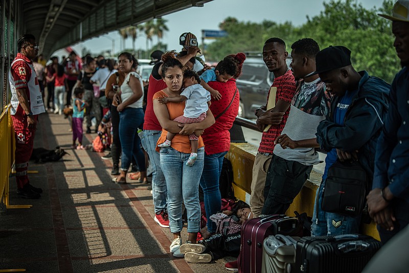 Photo/Meridith Kohut/The New York Times / Some of the first migrants to be processed in Brownsville, Texas, after Title 42 expired walk from Matamoros, Mexico, across the international bridge to present themselves to U.S. immigration officials on May 12, 2023.