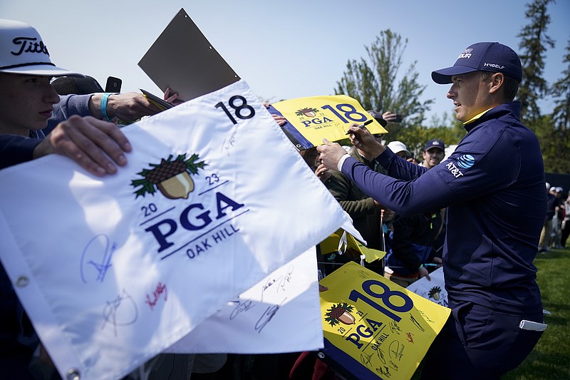 AP photo by Seth Wenig / Jordan Spieth signs autographs during a PGA Championship practice round Wednesday at Oak Hill Country Club in upstate New York. The Rochester-area course is set to host the PGA of America's premier event for a fourth time when it tees off Thursday.