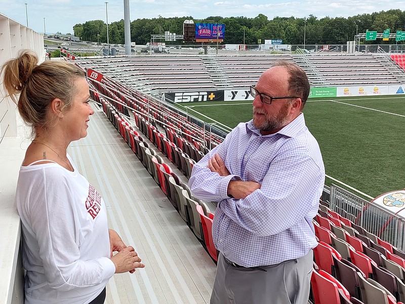 Staff Photo by Mike Pare / Sean McDaniel, right, Chattanooga Red Wolves president, talks with Caroline McWhorter, president of stadium development, at CHI Memorial Stadium on Friday.