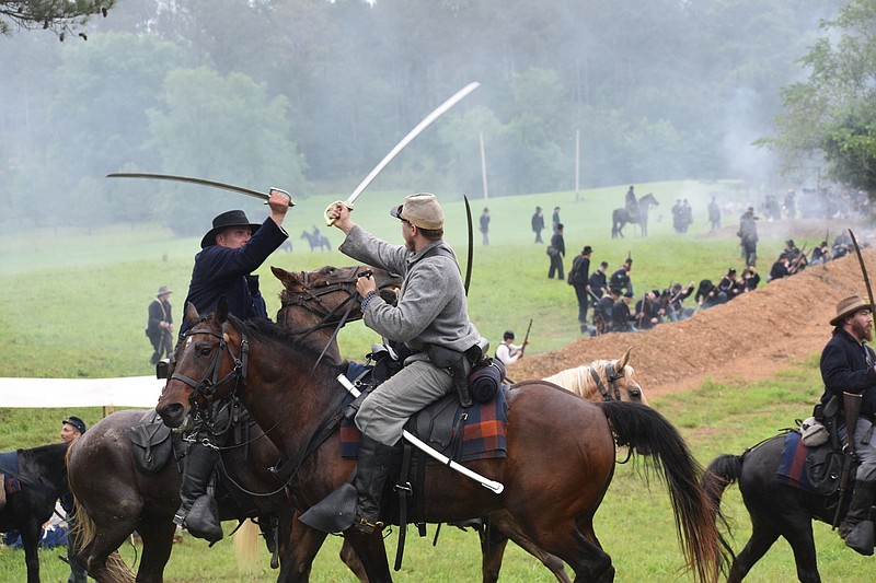 Staff Photo by Andrew Wilkins / Photographed on Saturday, Union and Confederate reenactors clash at the Battle of Resaca, Ga.