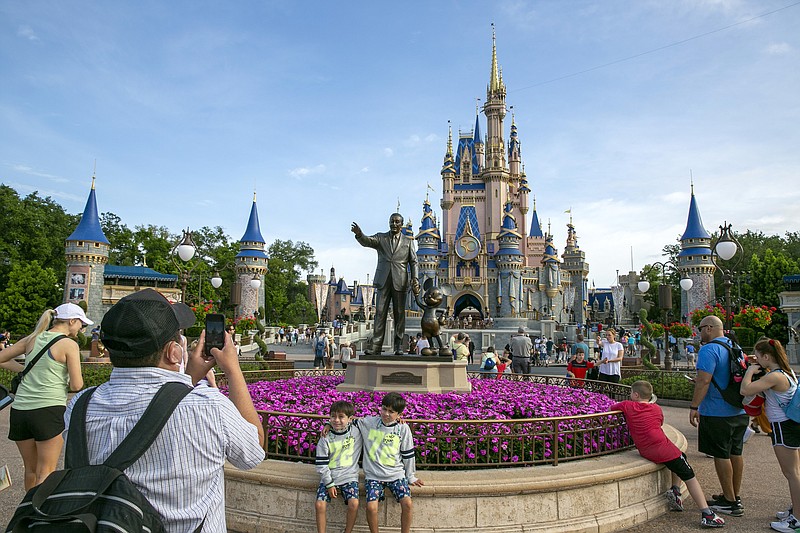 File photo/Ted Shaffrey/The Associated Press / People visit the Magic Kingdom Park at Walt Disney World Resort in Lake Buena Vista, Fla., on April 18, 2022. Amid Disney's ongoing feud with Florida Gov. Rion DeSantis, the company recently scuttled plans to build a massive new office complex in Orlando.