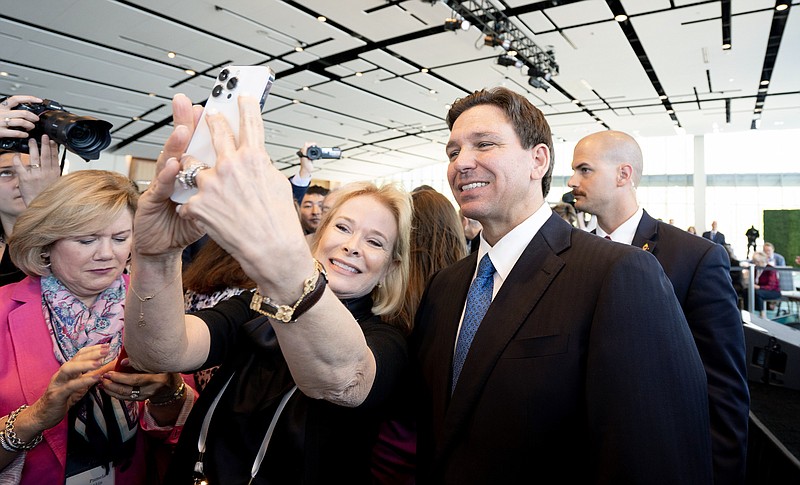 File photo/Leigh Vogel/The New York Times / Gov. Ron DeSantis of Florida poses for a photo with an attendee after speaking in National Harbor, Md., on April 21, 2023. DeSantis is expected to announce his candidacy for the GOP presidential nomination this week.