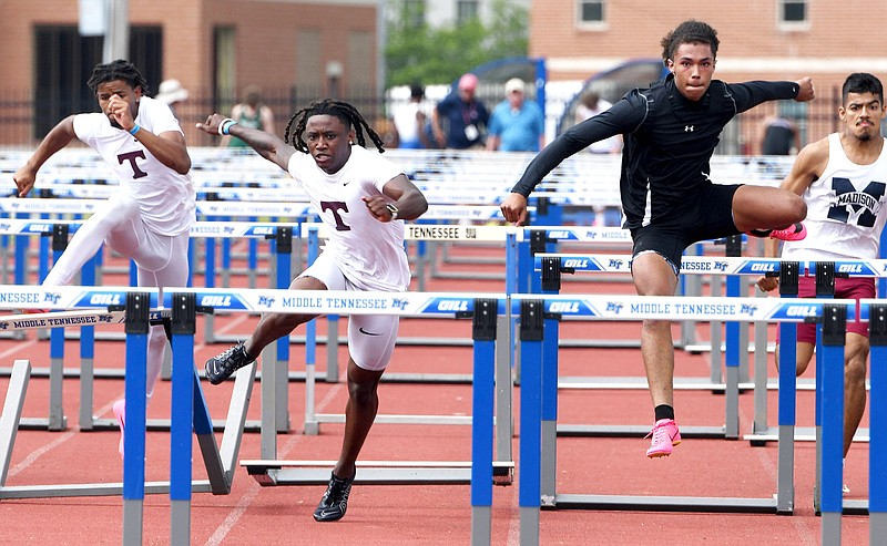 Staff Photo by Robin Rudd / South Pittsburg's Logan Hargis, in black, goes ahead to win the Class A 100 meter hurdles, as Tyner's Patrick Sullivan, left, and ZaShun Hubbard, center, fall behind.  Hargis's championship was the first ever for a Pirate track athelete.  TSSAA track was played at the Dean Hayes Stadium at Middle Tennessee State University in Murfreesboro on May 23, 2023.