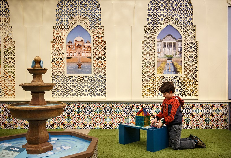 Staff Photo / A.J. Marshall uses building blocks to replicate mosque construction during the America to Zanzibar event day at the Creative Discovery Museum in 2018 in Chattanooga. The exhibit highlighted African Muslim culture and history in a way that was accessible to children.