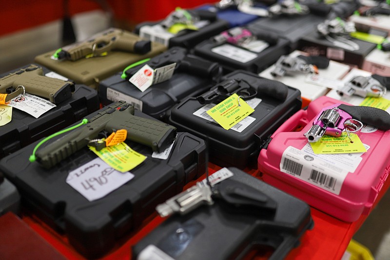 Staff photo by Olivia Ross / Guns from Bang Bang Guns out of Oakland, Tenn., are brought out during set up at the R.K. Camp Jordan Gun Show on May 26.