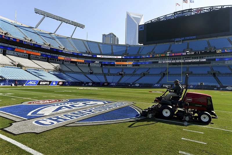 The Charlotte Observer photo by Diedra Laird via AP / Crews prepare the field at Bank of America Stadium for the ACC football title game in December 2017 in Charlotte, N.C.