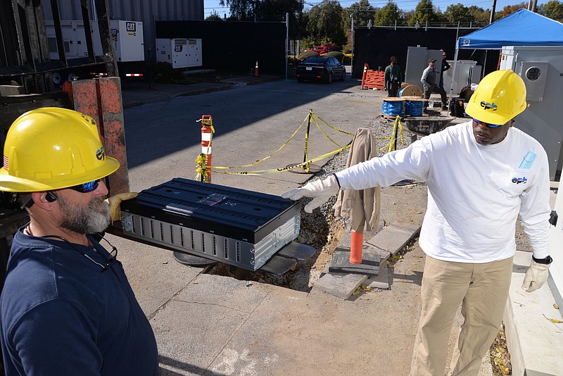 Contributed Photo / EPB workers install part of the microgrid to power the police and fire headquarters from solar panels, a diesel generator and a 500-kilowatt battery at the Amnicola Highway facility.