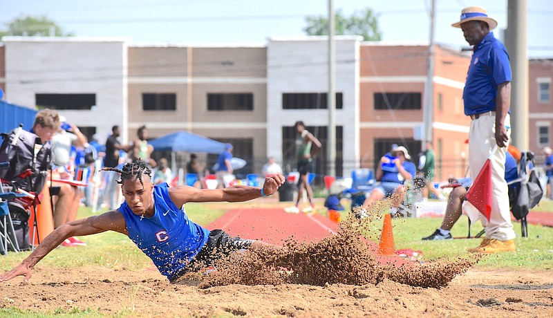 Staff photo by Patrick MacCoon / Cleveland senior D.J. Adams kicks up dirt on his landing while competing in the long jump during the TSSAA Class AAA state track and field meet Thursday at Middle Tennessee State University in Murfreesboro, Tenn.